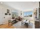 Spacious living room with hardwood floors, two leather chairs, and a scenic window view at 6030 Printery St # 108, Tampa, FL 33616