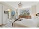 Spacious main bedroom with balcony access, a chandelier, and natural light at 6030 Printery St # 108, Tampa, FL 33616