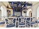Stylish outdoor bar featuring comfortable seating and a full bar setup under shaded pergola at 6030 Printery St # 108, Tampa, FL 33616