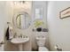 Stylish powder room featuring a mosaic mirror, pedestal sink, and neutral decor at 6030 Printery St # 108, Tampa, FL 33616