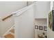 Bright staircase with wood handrail and white trim, leading to the upper level at 6030 Printery St # 108, Tampa, FL 33616