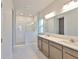Bright bathroom with double vanity, modern fixtures, and a walk-in shower at 6042 Golden Nettle Dr, Apollo Beach, FL 33572