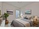 Comfortable bedroom featuring neutral colors, a large window, and tasteful decor creating a serene atmosphere at 6042 Golden Nettle Dr, Apollo Beach, FL 33572