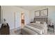 Bright bedroom with a view into the ensuite bathroom, with neutral walls and minimalistic decor at 6042 Golden Nettle Dr, Apollo Beach, FL 33572