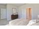 Cozy bedroom with neutral walls, minimalist decor, and a view into the ensuite bathroom at 6042 Golden Nettle Dr, Apollo Beach, FL 33572