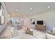 Bright open-concept living room with hardwood floors, neutral tones, modern lighting, and plenty of space at 6042 Golden Nettle Dr, Apollo Beach, FL 33572