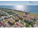Scenic aerial view of waterfront condos with red tile roofs, community pool, and lush landscaping near the bay at 6411 Mayra Shores Ln, Apollo Beach, FL 33572