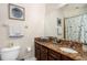 Bathroom featuring granite counters, ample cabinets, and coordinated nautical decor at 6411 Mayra Shores Ln, Apollo Beach, FL 33572