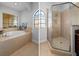 Bathroom with soaking tub and tiled shower in a well-lit room at 6411 Mayra Shores Ln, Apollo Beach, FL 33572