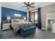 This beautifully decorated bedroom showcases a textured accent wall, balcony, and seating at 6411 Mayra Shores Ln, Apollo Beach, FL 33572