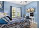 Blue bedroom with a comfortable bed and functional desk area at 6411 Mayra Shores Ln, Apollo Beach, FL 33572