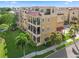 Stunning condo building featuring multiple balconies, a red tile roof, and lush landscaping at 6411 Mayra Shores Ln, Apollo Beach, FL 33572