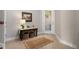 Foyer with tiled floor, accent table, and natural fiber rug at 6411 Mayra Shores Ln, Apollo Beach, FL 33572