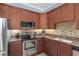 Stylish kitchen featuring granite countertops, stainless steel appliances, and ample cabinet space, ideal for culinary enthusiasts at 6411 Mayra Shores Ln, Apollo Beach, FL 33572