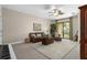 Spacious living room features a ceiling fan and glass sliding doors to the balcony at 6411 Mayra Shores Ln, Apollo Beach, FL 33572