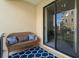 Exterior patio with a cozy bench and sliding glass door access to the inside at 6411 Mayra Shores Ln, Apollo Beach, FL 33572