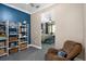 Sitting area with bookshelves and a glimpse into the Primary bedroom at 6411 Mayra Shores Ln, Apollo Beach, FL 33572