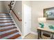 Staircase with colorful tile risers and wooden handrail adds charm at 6411 Mayra Shores Ln, Apollo Beach, FL 33572