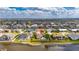Waterfront property featuring a private pool, green grass, and lush greenery at 811 Eagle Ln, Apollo Beach, FL 33572