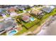Waterfront property featuring a private pool, green grass, and lush greenery at 811 Eagle Ln, Apollo Beach, FL 33572