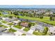 Beautiful aerial view of a home in a golf course community with canals and lush greenery at 811 Eagle Ln, Apollo Beach, FL 33572