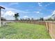 Large backyard with a wooden fence and sunny skies offers ample space and privacy at 811 Eagle Ln, Apollo Beach, FL 33572