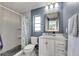 Bathroom featuring a tiled shower, toilet and sink with mirror at 811 Eagle Ln, Apollo Beach, FL 33572
