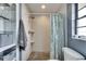 Modern bathroom features stone floor shower with glass shelves and gray towel at 811 Eagle Ln, Apollo Beach, FL 33572