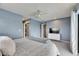 Comfortable bedroom with ceiling fan, dresser with TV and gray patterned bedspread at 811 Eagle Ln, Apollo Beach, FL 33572