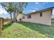 Exterior view of the home with a well-maintained lawn, trees, and serene landscape, with light shining at 811 Eagle Ln, Apollo Beach, FL 33572