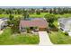Inviting single-story home featuring lush landscaping, a well-maintained lawn, and a charming front entrance with a 2 car garage at 811 Eagle Ln, Apollo Beach, FL 33572