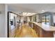Bright kitchen with stainless steel appliances, wood cabinets, and a view of the backyard swimming pool at 811 Eagle Ln, Apollo Beach, FL 33572