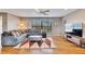 Comfortable living area with a sectional sofa, hardwood floors, and natural light from the window at 811 Eagle Ln, Apollo Beach, FL 33572