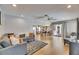 Open-concept living room with wood floors, modern furnishings, and a view of the kitchen at 811 Eagle Ln, Apollo Beach, FL 33572