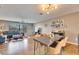 Open-concept living and dining area with hardwood floors, stylish furniture, and ample natural light, creating a welcoming atmosphere at 811 Eagle Ln, Apollo Beach, FL 33572