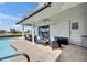 A covered patio features comfortable seating and views of the pool and backyard at 811 Eagle Ln, Apollo Beach, FL 33572