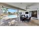 An inviting outdoor patio features a dining table and seating, overlooking the pool and picturesque backyard at 811 Eagle Ln, Apollo Beach, FL 33572