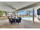 Covered patio with an outdoor dining area offers the perfect space to entertain poolside at 811 Eagle Ln, Apollo Beach, FL 33572