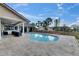 Stunning pool with outdoor seating, palm trees, and a fenced yard for a private oasis at 811 Eagle Ln, Apollo Beach, FL 33572