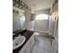 Cozy bathroom featuring a bathtub, window, single sink, and ample cabinet space at 8158 Eagles Park N Dr, St Petersburg, FL 33709