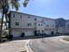 Three-story condo building with garages and well-maintained landscaping at 8158 Eagles Park N Dr, St Petersburg, FL 33709