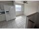 Bright eat-in kitchen area with white appliances and tile floors at 8158 Eagles Park N Dr, St Petersburg, FL 33709