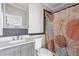 Bathroom featuring a modern vanity with a new countertop and leaf-patterned shower curtain at 8428 Highland Pines Ct, Plant City, FL 33565