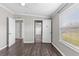 Bedroom featuring neutral walls, gray vinyl floors, and two closets with doors open at 8428 Highland Pines Ct, Plant City, FL 33565