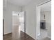 Bright hallway featuring wood floors and entryways to the bathroom and living room at 8428 Highland Pines Ct, Plant City, FL 33565