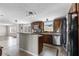 Modern kitchen featuring stainless steel appliances and granite countertops with a breakfast bar at 8428 Highland Pines Ct, Plant City, FL 33565