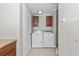 Bright laundry room with front load washer/dryer, tiled floor, and overhead cabinets at 8428 Highland Pines Ct, Plant City, FL 33565