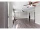Bright living room with hardwood floors, large windows, and modern ceiling fans at 8428 Highland Pines Ct, Plant City, FL 33565
