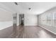 Open-concept living room with wood-look floors and abundant natural light at 8428 Highland Pines Ct, Plant City, FL 33565