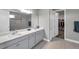 Modern bathroom with dual sinks, large mirror, and walk-in shower with tiled walls at 8816 Mugnai St, Riverview, FL 33578
